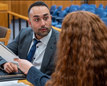 Students looking at each other in courtroom