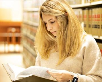 A student studies in the library. 