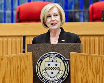 woman at a podium giving speech