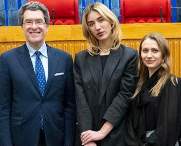 A professor and students in the Murray S. Love Moot Courtroom.